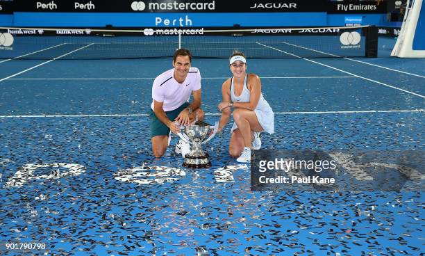 Roger Federer and Belinda Bencic of Switzerland pose with the Hopman Cup trophy after defeating Alexander Zverev and Angelique Kerber of Germany in...