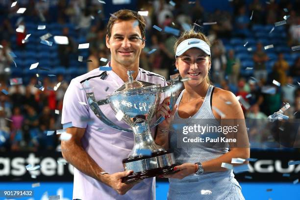 Roger Federer and Belinda Bencic of Switzerland pose with the Hopman Cup trophy after defeating Alexander Zverev and Angelique Kerber of Germany in...