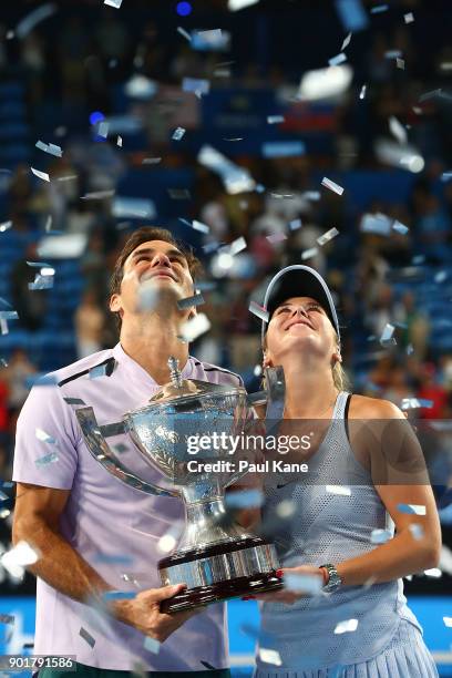 Roger Federer and Belinda Bencic of Switzerland pose with the Hopman Cup trophy after defeating Alexander Zverev and Angelique Kerber of Germany in...