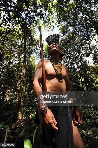 Malaysia-Penan-nomads-environment" by Sarah Stewart A member of a nomadic Penan tribe from the district of Ba Marong stays close to his sturdy...