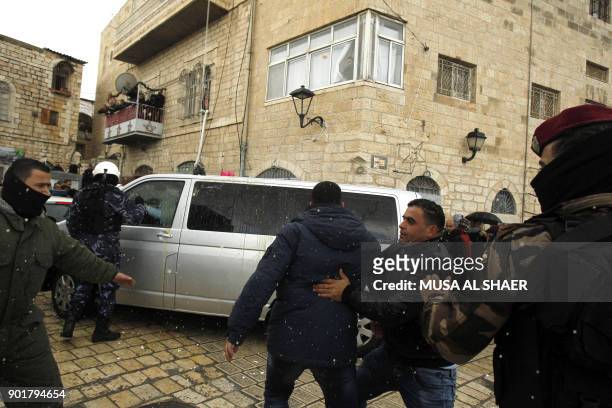 Palestinian security forces push away protesters from the convoy of Jerusalem's Greek Orthodox patriarch Theophilos III on its way to the church of...