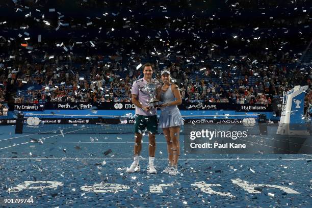 Roger Federer and Belinda Bencic of Switzerland pose with the Hopman Cup trophy after defeating Alexander Zverev and Angelique Kerber of Germany in...