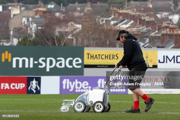 Groundsman paints the white lines on the pitch at St James Park the home stadium of Exeter City prior to the The Emirates FA Cup Third Round match...