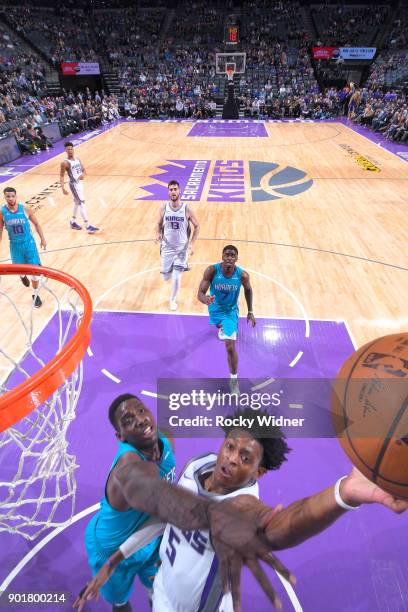 De'Aaron Fox of the Sacramento Kings shoots a layup against Johnny O'Bryant III of the Charlotte Hornets on January 2, 2018 at Golden 1 Center in...