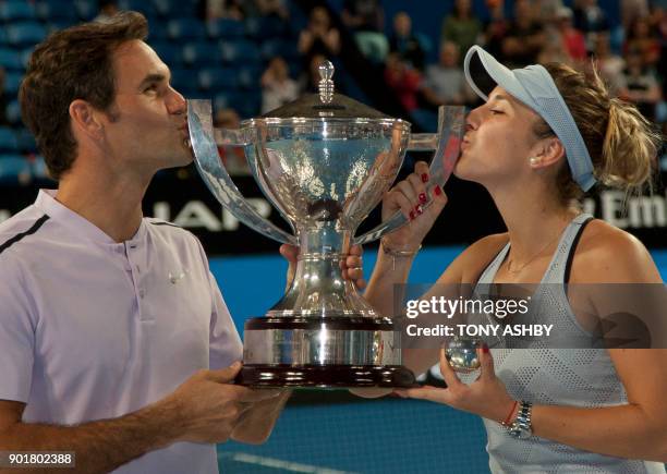 Roger Federer and Belinda Bencic of Switzerland hoist the Hopman Cup after defeating Alexander Zverev and Angelique Kerber of Germany in the mixed...