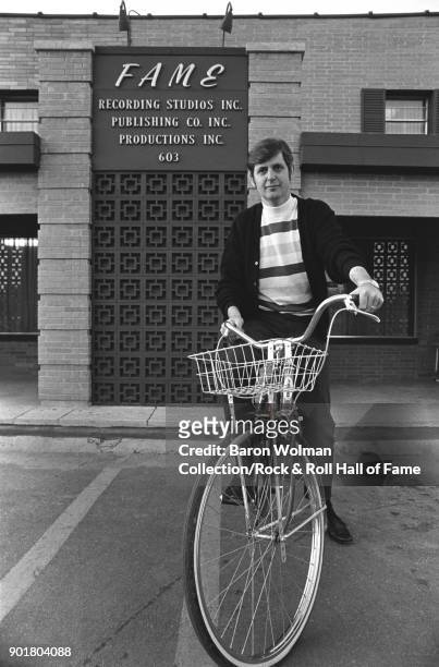 Record producer and recording studio owner Rick Hall , poses on a bicycle outside his FAME Studios in Muscle Shoals, Alabama, March 1969.