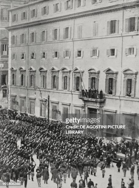 Benito Mussolini on the balcony of Palazzo Chigi receiving New Year wishes from the Roman fascists, Rome, Italy, from L'Illustrazione Italiana, Year...