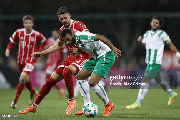 Sandro Wagner of Muenchen is challenged by Khalil Shreff of Al Ahli during the friendly match between Al-Ahli and Bayern Muenchen on day 5 of the FC...