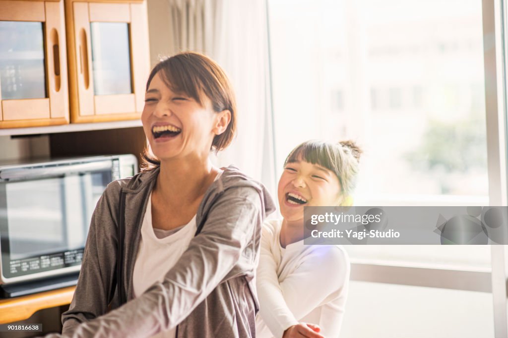Mother and daughter exercising together in home