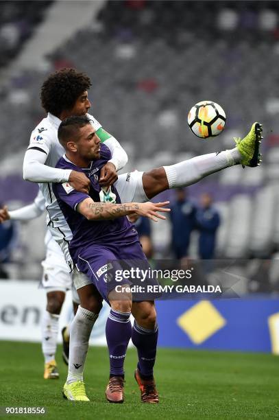 Nice's captain and defender Dante Costa Santos battles for an aerial ball against Toulouse's forward Andy Delort during the French cup football match...