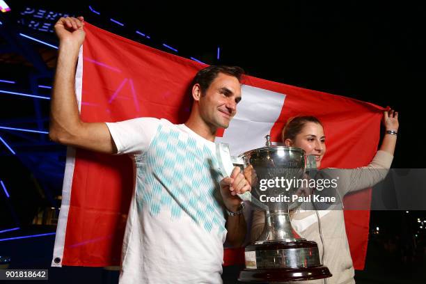 Roger Federer and Belinda Bencic of Switzerland pose with the Hopman Cup trophy after defeating Alexander Zverev and Angelique Kerber of Germany in...