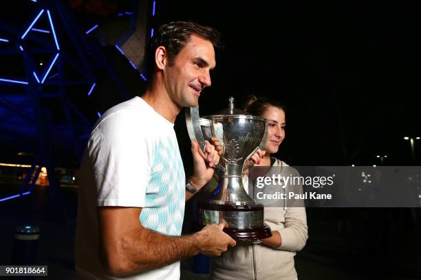 Roger Federer and Belinda Bencic of Switzerland pose with the Hopman Cup trophy after defeating Alexander Zverev and Angelique Kerber of Germany in...