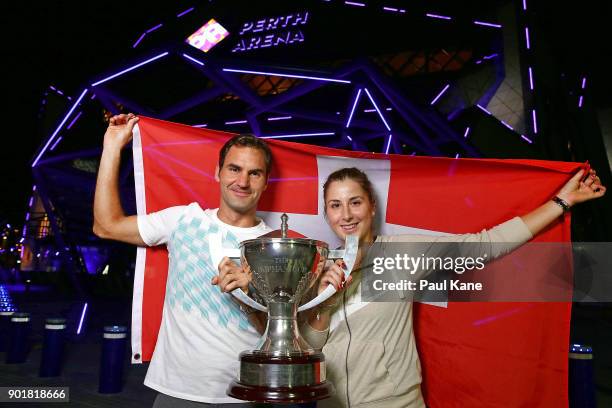 Roger Federer and Belinda Bencic of Switzerland pose with the Hopman Cup trophy after defeating Alexander Zverev and Angelique Kerber of Germany in...