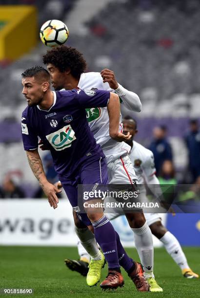 Nice's captain and defender Dante Costa Santos battles for an aerial ball against Toulouse's forward Andy Delort during the French Cup football match...