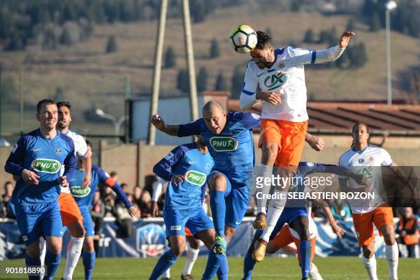 Montpellier's Portuguese defender Pedro Mendes vies with Pontarlier's Brazilian midfielder Junior Carlos Miranda during the French Cup football match...