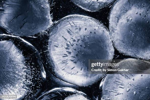 extreme close up of ice spheres floating on water - icicle macro stock pictures, royalty-free photos & images