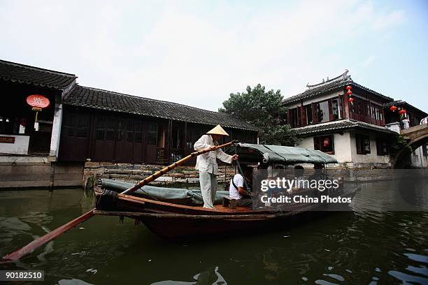 Tourists take a sightseeing boat on a canal on August 29, 2009 in Zhouzhuang Town of Kunshan City, Jiangsu Province, China. Zhouzhuang, first built...