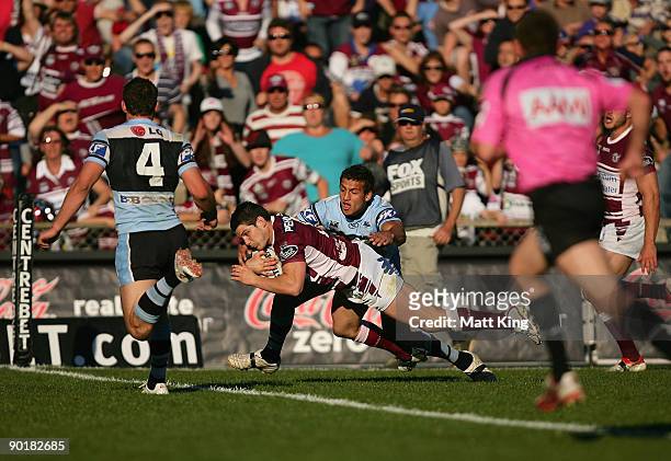 Ben Farrar of the Sea Eagles dives over the line to score the match winning try during the round 25 NRL match between the Manly-Warringah Sea Eagles...