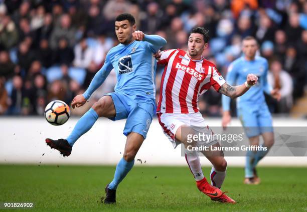 Maxime Biamou of Coventry City and Geoff Cameron of Stoke City during the The Emirates FA Cup Third Round match between Coventry City and Stoke City...