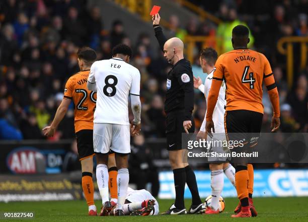 Referee Anthony Taylor shows Ruben Vinagre of Wolverhampton Wanders a red card during The Emirates FA Cup Third Round match between Wolverhampton...