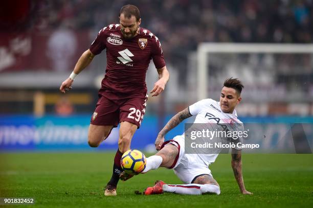 Lorenzo De Silvestri of Torino FC is tackled by Erick Pulgar of Bologna FC during the Serie A football match between Torino FC and Bologna FC. Torino...