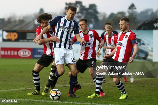 Gareth McAuley of West Bromwich Albion is held by Daniel Seaborne of Exeter City during to the The Emirates FA Cup Third Round match between Exeter...