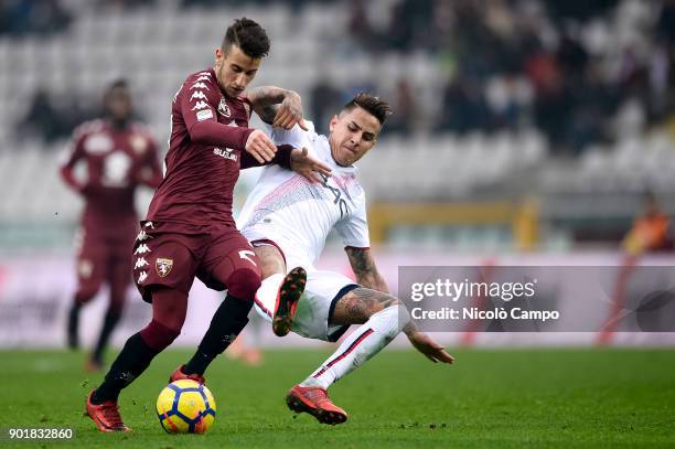 Alex Berenguer of Torino FC competes for the ball with Erick Pulgar of Bologna FC during the Serie A football match between Torino FC and Bologna FC....