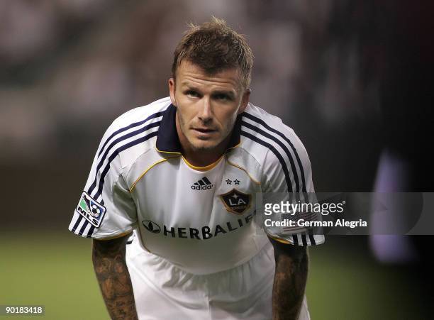 David Beckham of the Los Angeles Galaxy pauses to receive instructions from the bench during his MLS match against Chivas USA on August 29, 2009 at...
