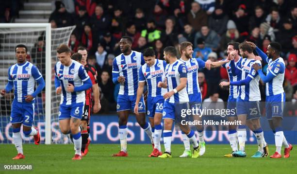 Nick Powell of Wigan Athletic is congratulated by team mates as they celebrate the own goal scored by Emerson Hyndman of AFC Bournemouth during The...