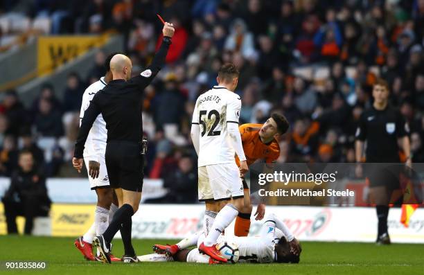 Referee Anthony Taylor shows Ruben Vinagre of Wolverhampton Wanders a red card during The Emirates FA Cup Third Round match between Wolverhampton...