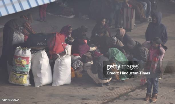 Passengers waiting for their trains at Old Delhi Railway station during a cold and foggy weather, on January 06, 2018 in New Delhi Area, India. As...