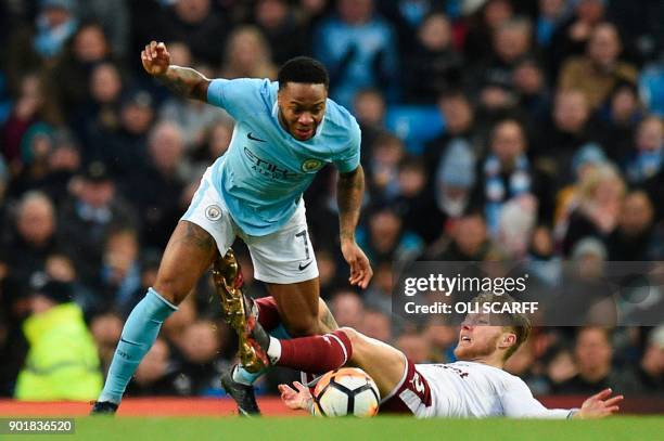 Manchester City's English midfielder Raheem Sterling gets tackled by Burnley's Irish midfielder Jeff Hendrick during the English FA Cup third round...