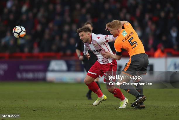 Matt Godden of Stevenage turns away from Paul McShane of Reading during The Emirates FA Cup Third Round match between Stevenage and Reading at The...