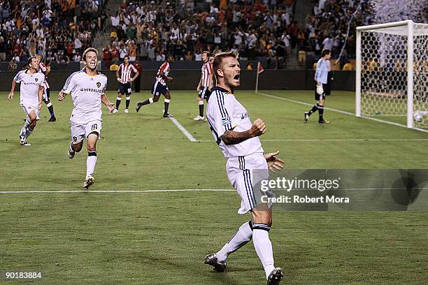 David Beckham of the Los Angeles Galaxy celebrates scoring the game winning goal against Chivas USA during their MLS game at The Home Depot Center on...