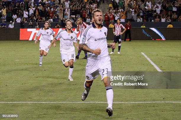 David Beckham of the Los Angeles Galaxy celebrates scoring the game winning goal against Chivas USA during their MLS game at The Home Depot Center on...