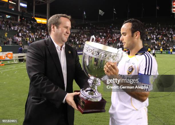 Landon Donovan of the Los Angeles Galaxy receives the SuperClasico Trophy after defeating Chivas USA on August 29, 2009 at the Home Depot Center in...