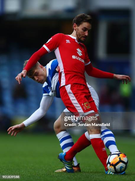 Ed Upson of MK Dons tackles with Jake Bidwell of QPR during The Emirates FA Cup Third Round match between Queens Park Rangers and Milton Keynes Dons...