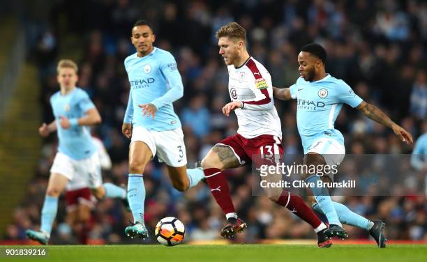 Jeff Hendrick of Burnley is tackled by Raheem Sterling and Danilo of Manchester City during the The Emirates FA Cup Third Round match between...