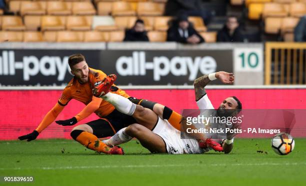 Wolverhampton Wanderers' Matt Doherty and Swansea City's Kyle Bartley battle for the ball during the FA Cup, third round match at Molineux Stadium,...
