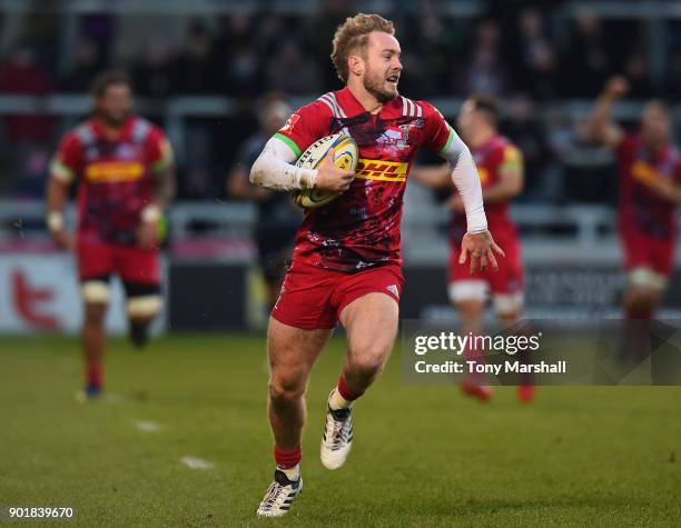 Charlie Walker of Harlequins runs in to score their second try during the Aviva Premiership match between Sale Sharks and Harlequins at AJ Bell...