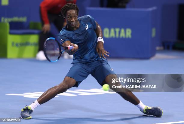 Gael Monfils of France returns the ball to Russia's Andrey Rublev during the ATP Qatar Open tennis competition in Doha on January 6, 2018. / AFP...