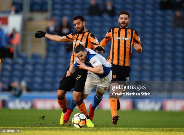 Craig Conway of Blackburn Rovers is tackled by Kevin Stewart of Hull City during The Emirates FA Cup Third Round match between Blackburn Rovers and...