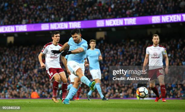 Sergio Aguero of Manchester City scores the first goal during The Emirates FA Cup Third Round match between Manchester City and Burnley at Etihad...