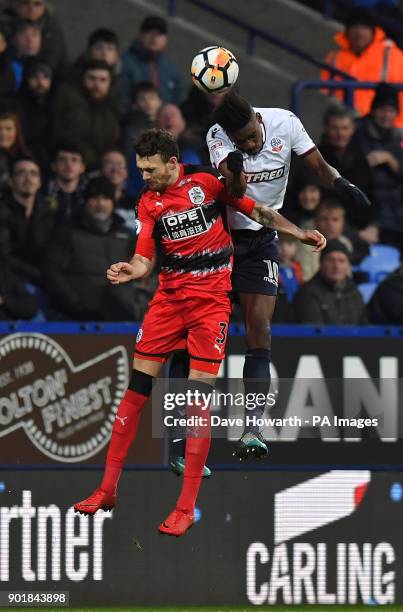 Bolton Wanderers' Sammy Ameobi out jumps Huddersfield Town's Scott Malone during the FA Cup, third round match at the Macron Stadium, Bolton.