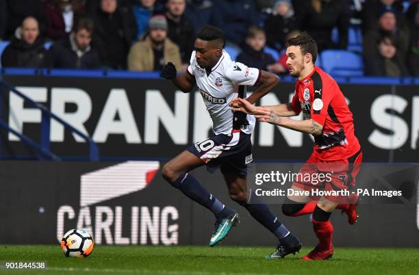 Bolton Wanderers' Sammy Ameobi holds off Huddersfield Town's Scott Malone during the FA Cup, third round match at the Macron Stadium, Bolton.