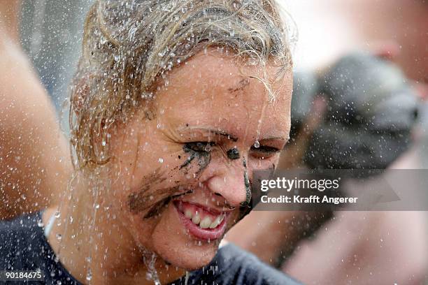 Participants shower after the football matches during the Mudflat Olympic Games on August 30, 2009 in Brunsbuttel, Germany.