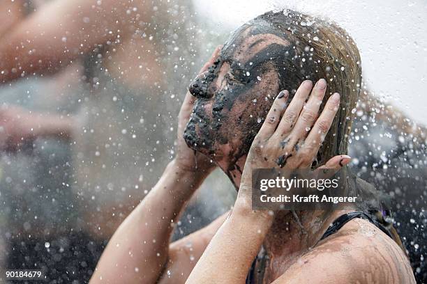 Participants shower after the football matches during the Mudflat Olympic Games on August 30, 2009 in Brunsbuttel, Germany.