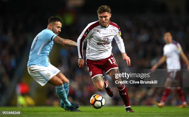 Jeff Hendrick of Burnley and Nicolas Otamendi of Manchester City in action during the The Emirates FA Cup Third Round match between Manchester City...