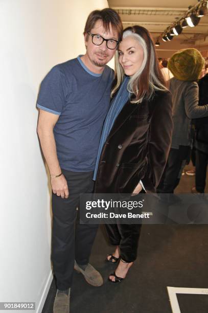 Oliver Spencer and Catherine Hayward pose backstage at the Oliver Spencer LFWM AW18 Catwalk Show at the BFC Show Space on January 6, 2018 in London,...