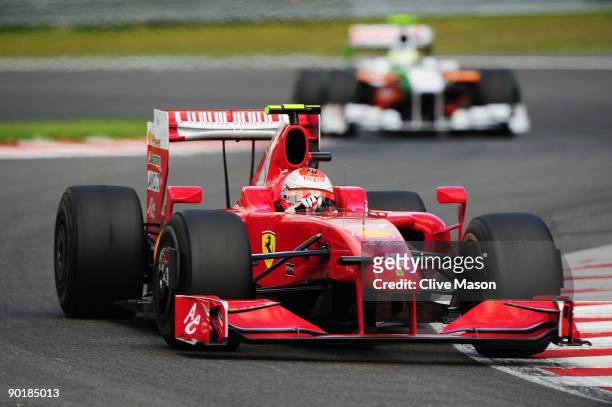 Race winner Kimi Raikkonen of Finland and Ferrari leads from second placed Giancarlo Fisichella of Italy and Force India during the Belgian Grand...
